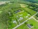 Scenic aerial shot showcases multiple houses, a pond, and sprawling fields at 2829 Highway 129, Galivants Ferry, SC 29544