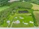 Expansive property with a pond, lush greenery, outbuildings and a long driveway at 2829 Highway 129, Galivants Ferry, SC 29544