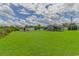 Expansive green backyard with multiple outbuildings, offering ample space and storage options at 2829 Highway 129, Galivants Ferry, SC 29544