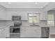 Well-lit kitchen with stainless steel appliances, quartz counters, and modern fixtures at 2829 Highway 129, Galivants Ferry, SC 29544