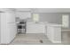 Bright kitchen with white cabinets and stainless steel appliances, open to the living area at 2829 Highway 129, Galivants Ferry, SC 29544