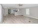 Open-concept living room with modern flooring, seamlessly connecting to a bright, white kitchen at 2829 Highway 129, Galivants Ferry, SC 29544