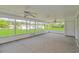 Screened patio featuring ceiling fans and an expansive backyard view, perfect for outdoor living at 2829 Highway 129, Galivants Ferry, SC 29544