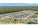 Wide aerial view of a well-planned community featuring homes, a pond, and lush trees at 2885 Desert Rose St., Little River, SC 29566
