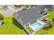 Aerial view of a backyard with a sparkling pool, a gazebo, and lush green landscaping at 2885 Desert Rose St., Little River, SC 29566