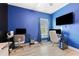 Gaming bedroom features blue walls, hardwood floors and work stations with multiple screens and plush chair at 2885 Desert Rose St., Little River, SC 29566
