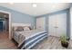 Bright bedroom with light blue walls and wood-look flooring featuring a bed and closet at 2885 Desert Rose St., Little River, SC 29566