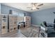Bedroom features blue walls, hardwood floors, ceiling fan and black work station with white bookshelves at 2885 Desert Rose St., Little River, SC 29566