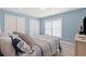 Bedroom featuring light blue walls and wood-look flooring featuring a bed, TV, and closet at 2885 Desert Rose St., Little River, SC 29566