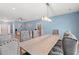 Elegant dining room area featuring a long table with upholstered chairs and a modern light fixture at 2885 Desert Rose St., Little River, SC 29566