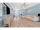 Spacious living room with hardwood floors, a ceiling fan, a large sectional sofa, and a wall-mounted television at 2885 Desert Rose St., Little River, SC 29566