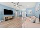 Bright living room with hardwood floors, a ceiling fan, a large sectional sofa, and ample natural light at 2885 Desert Rose St., Little River, SC 29566