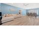 Open-concept living space featuring hardwood floors, comfortable seating, and a dining area with seating for six at 2885 Desert Rose St., Little River, SC 29566