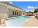 Inviting backyard pool with a covered patio, outdoor seating, and a well-maintained deck at 2885 Desert Rose St., Little River, SC 29566