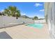 Private outdoor pool featuring a pristine pool, white fencing and a paved concrete patio at 2885 Desert Rose St., Little River, SC 29566