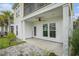 A covered back porch with a ceiling fan looks out onto the landscaped backyard at 294 Splendor Circle, Murrells Inlet, SC 29576