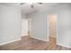 Bedroom with gray walls, wood-look flooring, a closet, and doorway with views of the home's interior at 294 Splendor Circle, Murrells Inlet, SC 29576