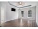 Spacious bedroom featuring wood-look floors, large windows, and a modern ceiling fan for comfort at 294 Splendor Circle, Murrells Inlet, SC 29576