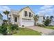 Charming yellow two-story home with a white garage, black shutters and well-manicured lawn at 294 Splendor Circle, Murrells Inlet, SC 29576