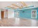 Open living room featuring wood-look flooring, wood beam ceiling, and a barn door at 294 Splendor Circle, Murrells Inlet, SC 29576