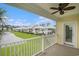 Scenic patio view with a ceiling fan overlooking manicured lawns and neighborhood homes under a sunny sky at 294 Splendor Circle, Murrells Inlet, SC 29576