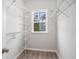 Well-organized walk-in closet featuring ample shelving and a window for natural light at 294 Splendor Circle, Murrells Inlet, SC 29576
