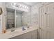 Bright bathroom featuring double sinks, a large mirror, and seashell-themed wallpaper at 3307 Nixon St., North Myrtle Beach, SC 29582
