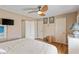 Cozy bedroom with a ceiling fan, white armoire, and warm, inviting decor at 3307 Nixon St., North Myrtle Beach, SC 29582