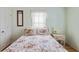 Bright bedroom featuring floral bedding, neutral walls and a window with sheer lace valance at 3307 Nixon St., North Myrtle Beach, SC 29582