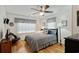 Cozy bedroom with a ceiling fan, wood floors, Americana decor, and natural light from the window at 3307 Nixon St., North Myrtle Beach, SC 29582
