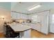 A cozy kitchen features white cabinets, a breakfast bar and modern appliances at 3307 Nixon St., North Myrtle Beach, SC 29582