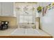Bright kitchen with a double sink, charming window treatments, and cheerful decor at 3307 Nixon St., North Myrtle Beach, SC 29582