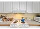 Well-lit kitchen with white cabinets, a white stove, and a decorative countertop at 3307 Nixon St., North Myrtle Beach, SC 29582