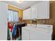 Functional laundry room with washer, dryer, shelving, and natural light coming from the window at 3307 Nixon St., North Myrtle Beach, SC 29582
