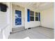 Covered front porch with blue door and storm door, and a ceiling fan at 333 Walden Lake Rd., Conway, SC 29526