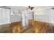 Open-concept living space flowing into kitchen with hardwood floors and neutral walls at 333 Walden Lake Rd., Conway, SC 29526