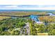 Community aerial view showcasing the pool, tennis courts, parking, boat storage, and extensive treed landscape at 35 Easter Lilly Ct., Murrells Inlet, SC 29576