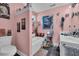 Pink-themed bathroom with a soaking tub, vanity, and unique decor at 35 Easter Lilly Ct., Murrells Inlet, SC 29576