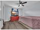 Spacious bedroom featuring a ceiling fan and television atop a red dresser for entertainment at 35 Easter Lilly Ct., Murrells Inlet, SC 29576