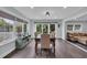 Bright dining room with dark floors, large windows, and view of the backyard at 35 Easter Lilly Ct., Murrells Inlet, SC 29576