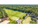 Expansive aerial view of the lush golf course, featuring manicured greens and scenic fairways at 35 Easter Lilly Ct., Murrells Inlet, SC 29576
