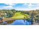 Scenic view of the golf course bordering a tranquil pond, showcasing the property's recreational amenities at 35 Easter Lilly Ct., Murrells Inlet, SC 29576