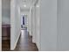 Hallway with hardwood floors and several doors leading to bedrooms and other living spaces at 35 Easter Lilly Ct., Murrells Inlet, SC 29576
