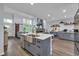Spacious kitchen with island seating, modern appliances, and open to the living area with fireplace at 35 Easter Lilly Ct., Murrells Inlet, SC 29576