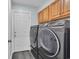 Laundry room featuring wood cabinets above a modern washer and dryer for convenience at 35 Easter Lilly Ct., Murrells Inlet, SC 29576