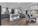 Spacious living room with view of kitchen, dining, and staircase with natural light, and wood flooring at 35 Easter Lilly Ct., Murrells Inlet, SC 29576