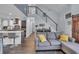 Open concept living area with modern staircase, seamless flow to the kitchen, and barn door at 35 Easter Lilly Ct., Murrells Inlet, SC 29576