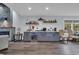 Entertainment area featuring stone fireplace, bar with a beverage fridge, and ample cabinet space at 35 Easter Lilly Ct., Murrells Inlet, SC 29576