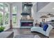 Modern living room featuring a stone fireplace, ample natural light, and stylish decor at 35 Easter Lilly Ct., Murrells Inlet, SC 29576