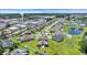 Stunning aerial view of a neighborhood, showcasing houses, a pond, and green spaces, with the ocean in the background at 356 Ocean Commons Dr., Surfside Beach, SC 29575